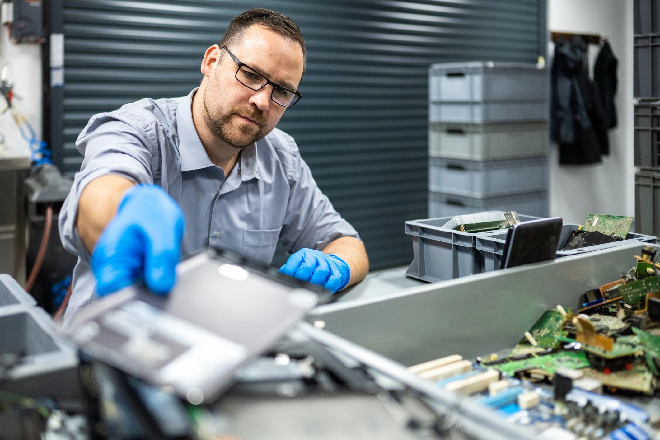 Technician carefully repairing an electronic device