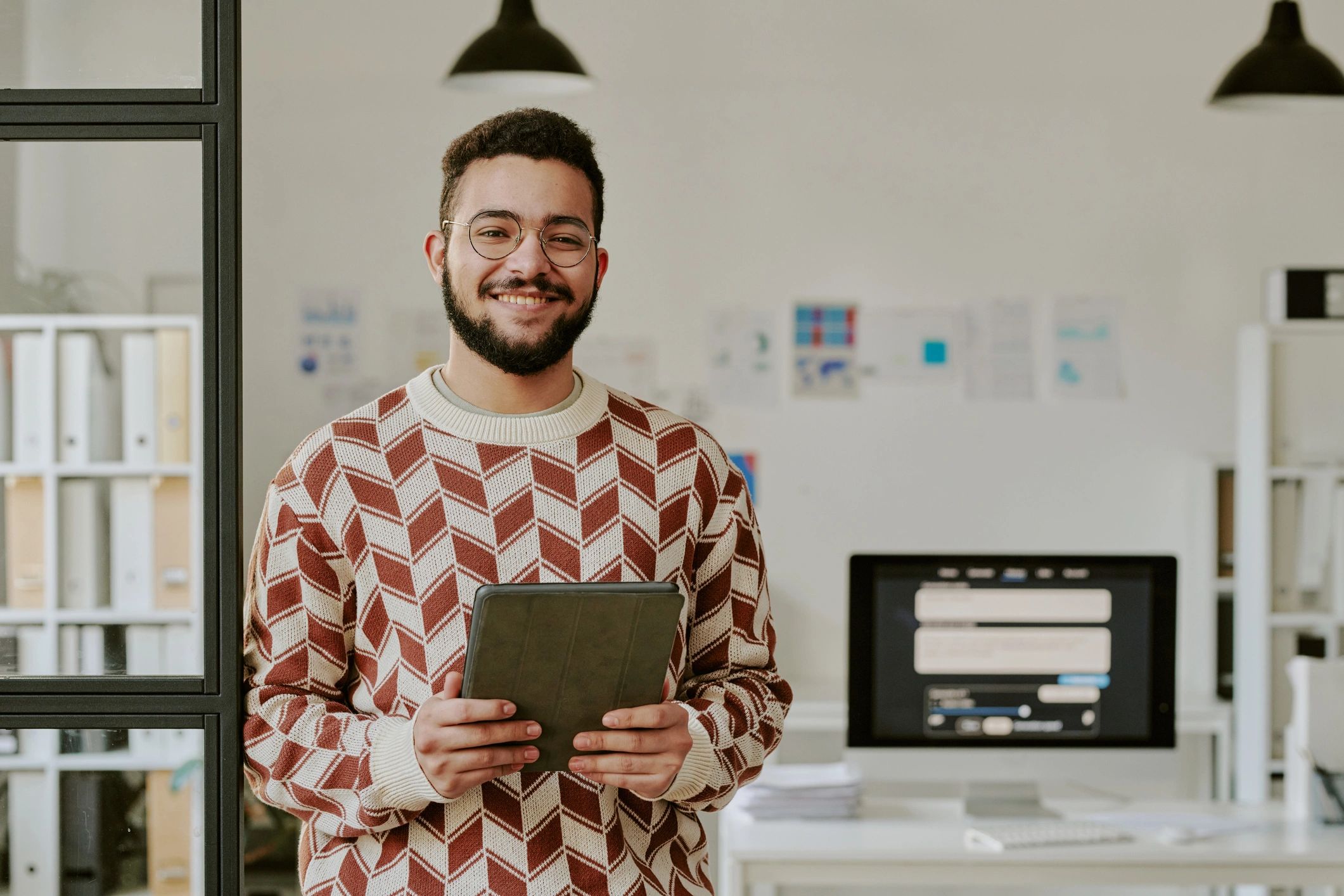 IT support professional holding a tablet in an office