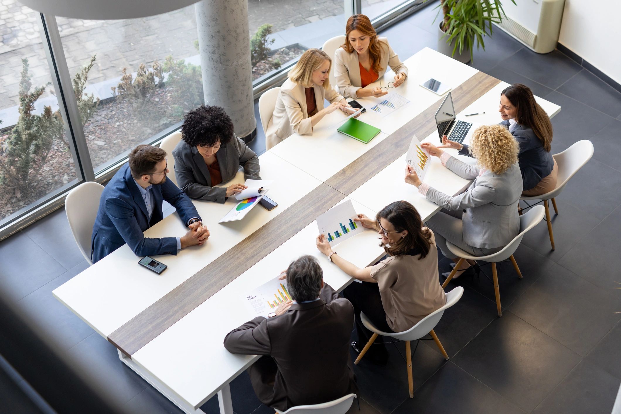 Team collaborating with laptops in a modern office